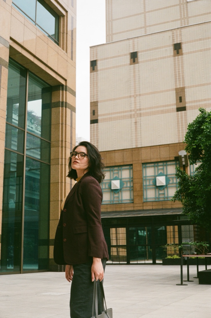 Filananda Andries in a blazer among city buildings