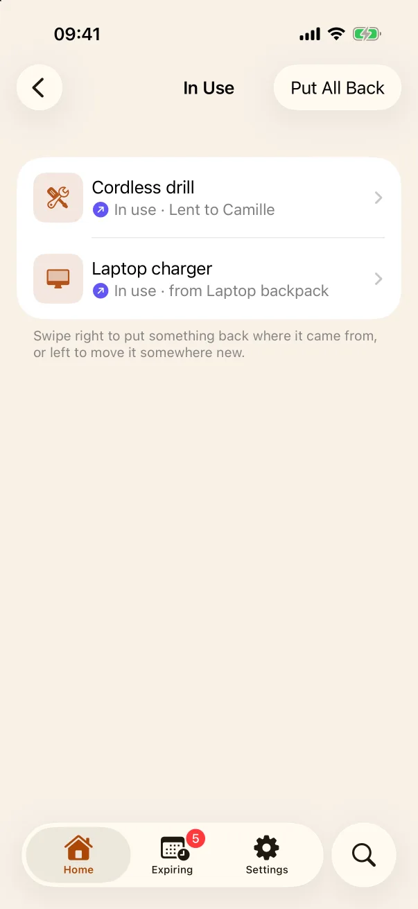 The In Use screen: a cordless drill lent to Camille and a laptop charger taken from the laptop backpack, with a Put All Back button.